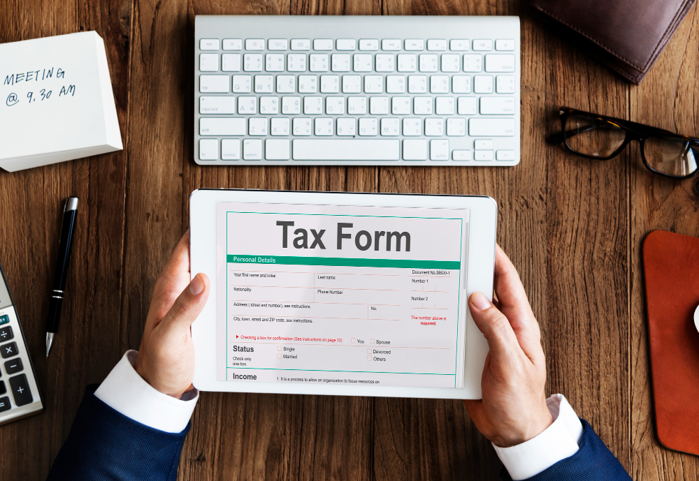 Business owner dealing with tax on his tablet