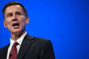 Britain's Chancellor of the Exchequer Jeremy Hunt addresses delegates at the annual Conservative Party Conference in Manchester, northern England, on October 2, 2023. Will be giving Autumn Statement 2023