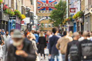 Shoppers in Carnaby Street, London. Vat-free shopping concept.